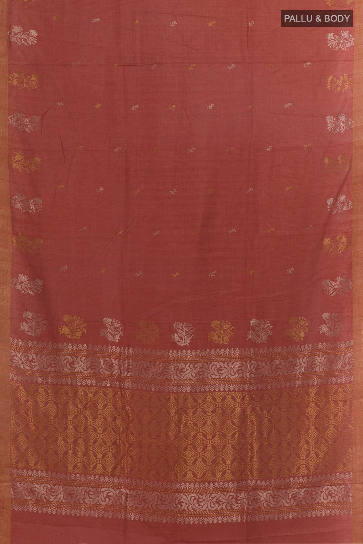 Flat view of Rust Tussar Saree with Zari Butta on the body and Zari Border. 