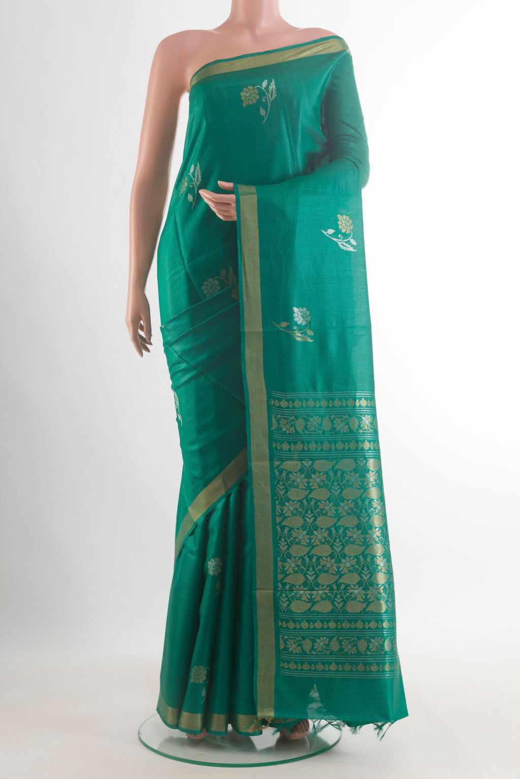 Green Tussar Saree with Zari Butta on the body and Zari Border.  displayed on a mannequin