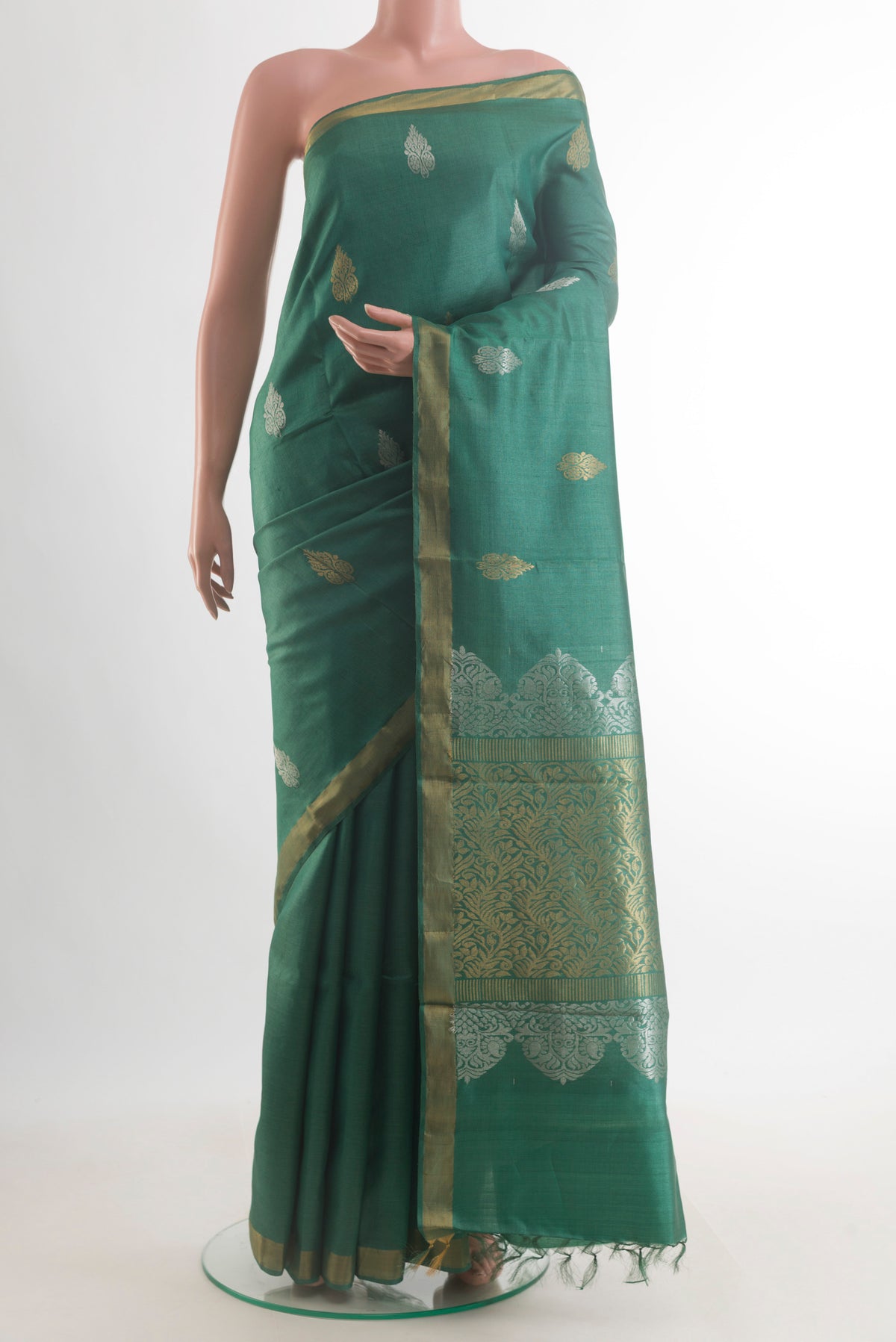 Green Tussar Saree with Zari Butta on the body and Zari Border.  displayed on a mannequin