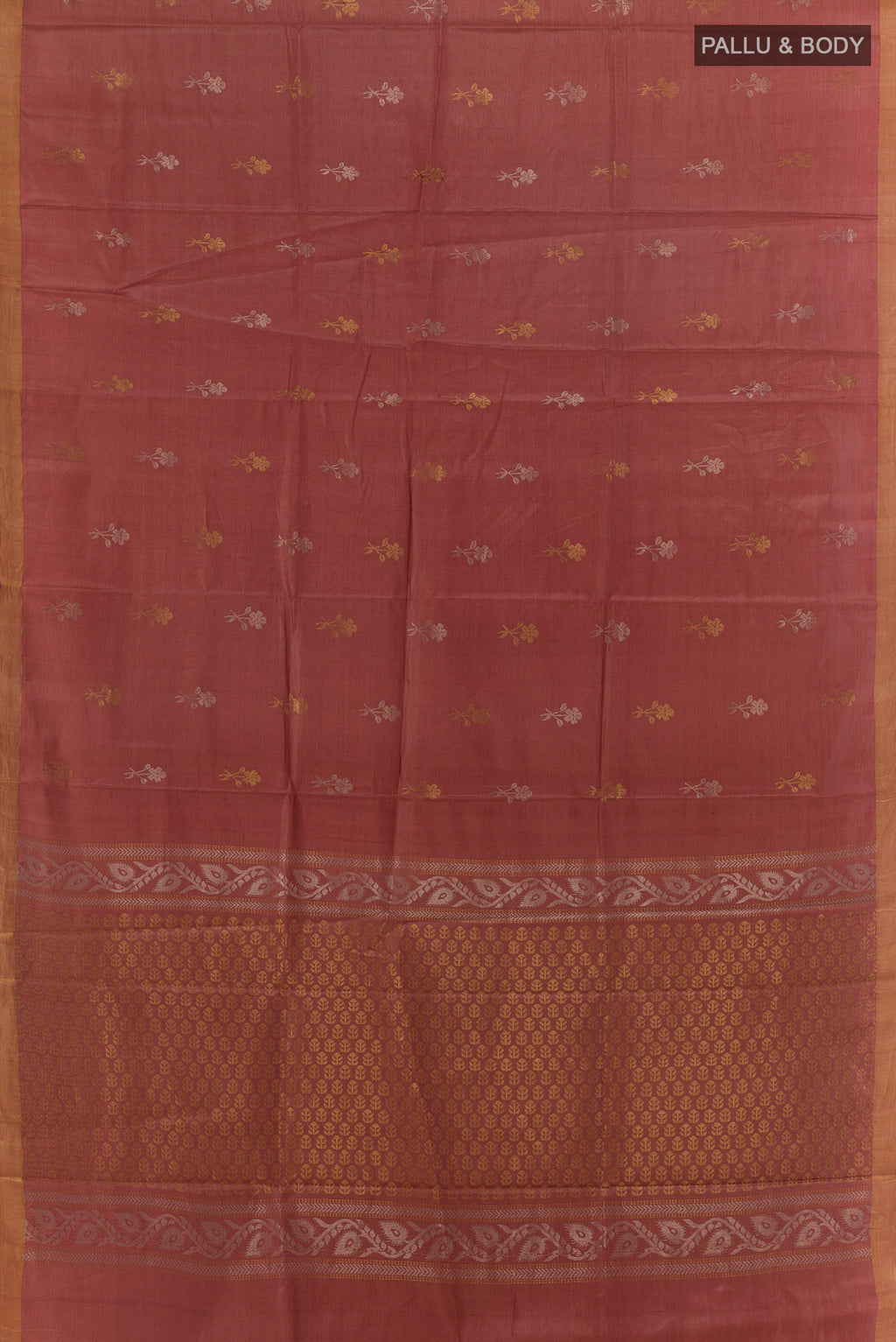 Flat view of Rust Tussar Saree with Zari Butta on the body and Zari Border. 