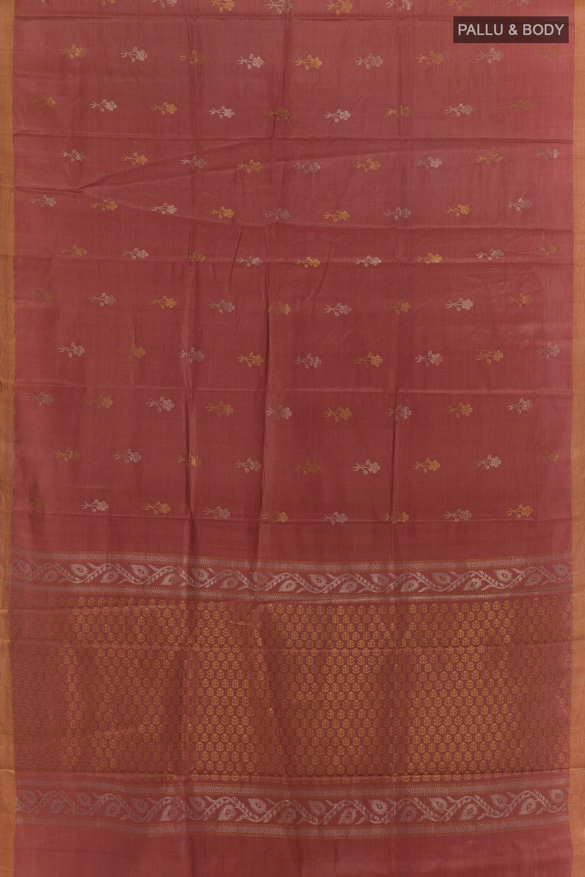 Flat view of Rust Tussar Saree with Zari Butta on the body and Zari Border. 