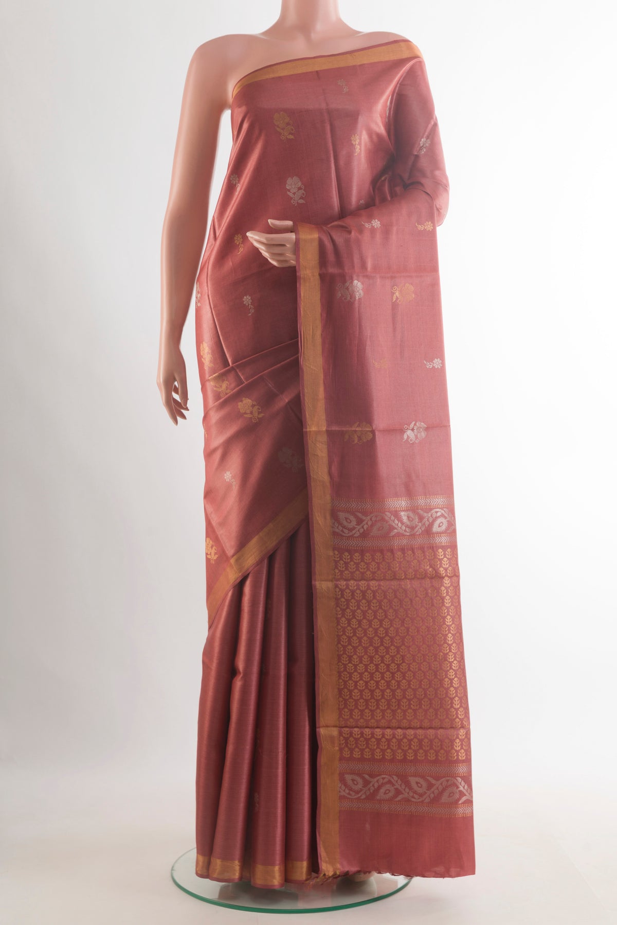 Rust Tussar Saree with Zari Butta on the body and Zari Border.  displayed on a mannequin