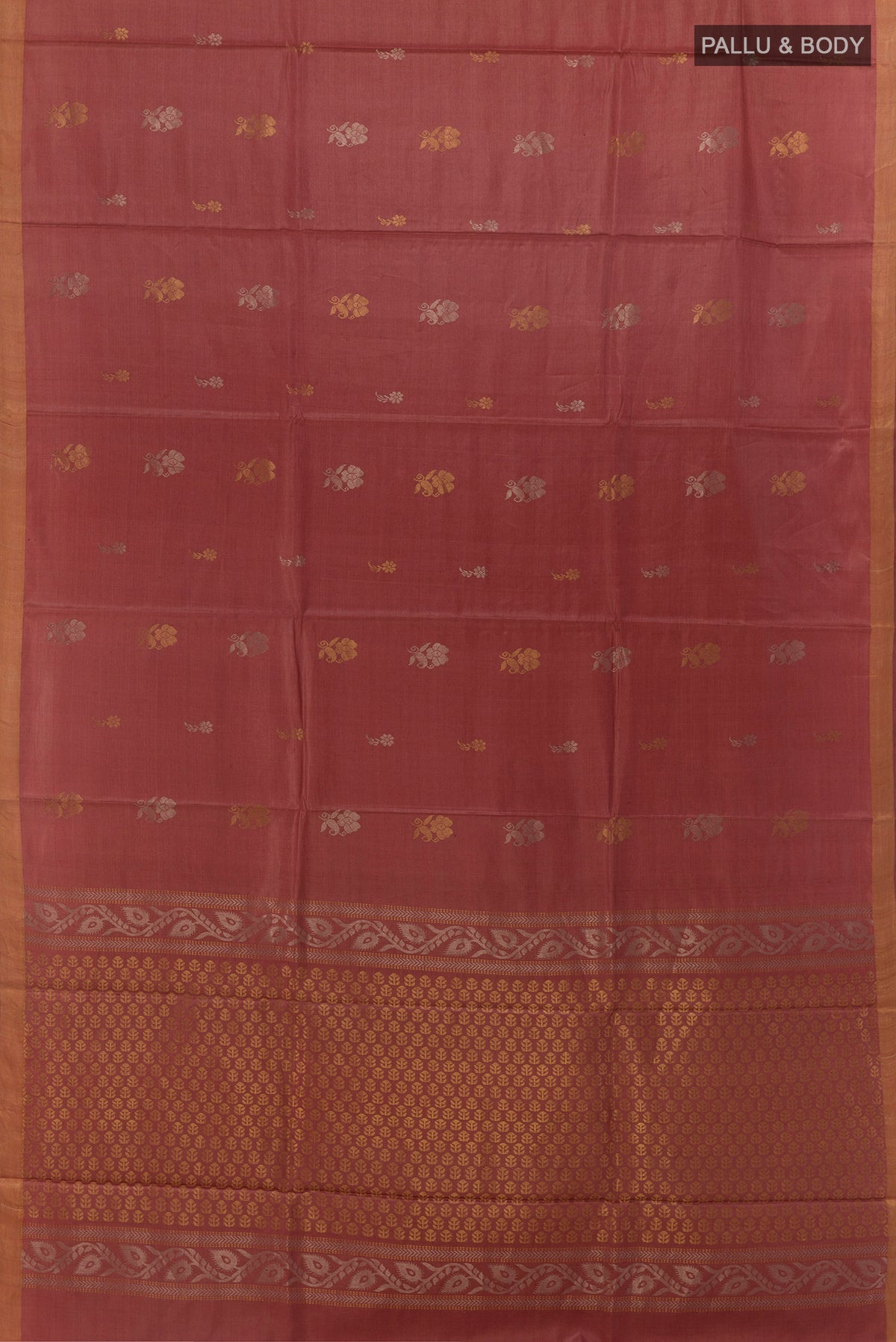 Flat view of Rust Tussar Saree with Zari Butta on the body and Zari Border. 