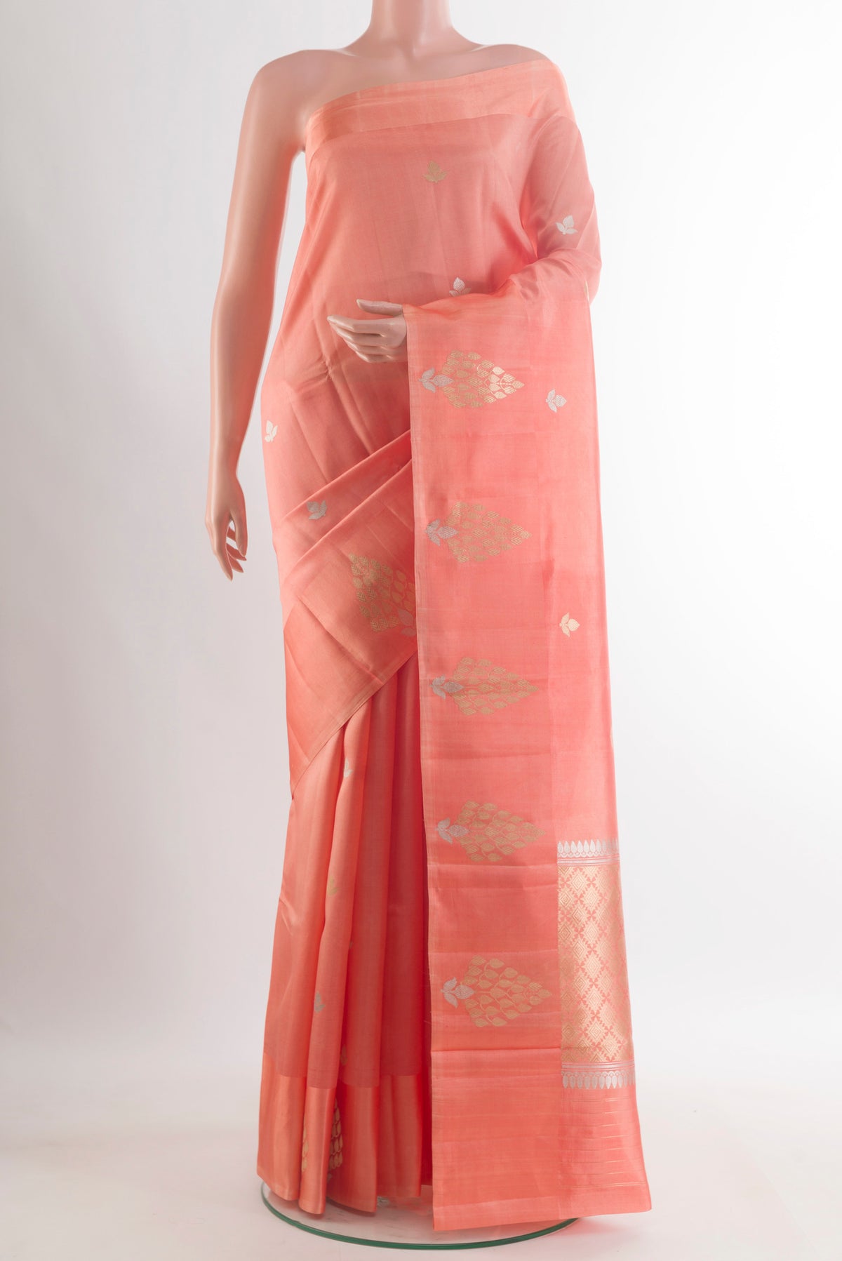 Pure Silk Peach Banarasi Katan Saree with Zari Butta on the body and Zari Border.  displayed on a mannequin