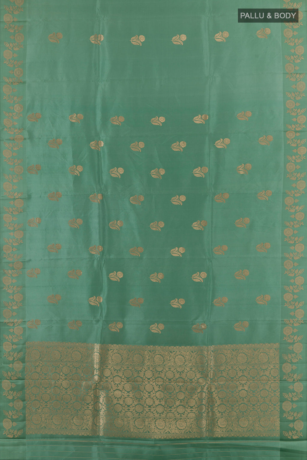 Flat view of Pure Silk Sage Green Banarasi Katan Saree with Zari Butta on the body and Zari Border. 