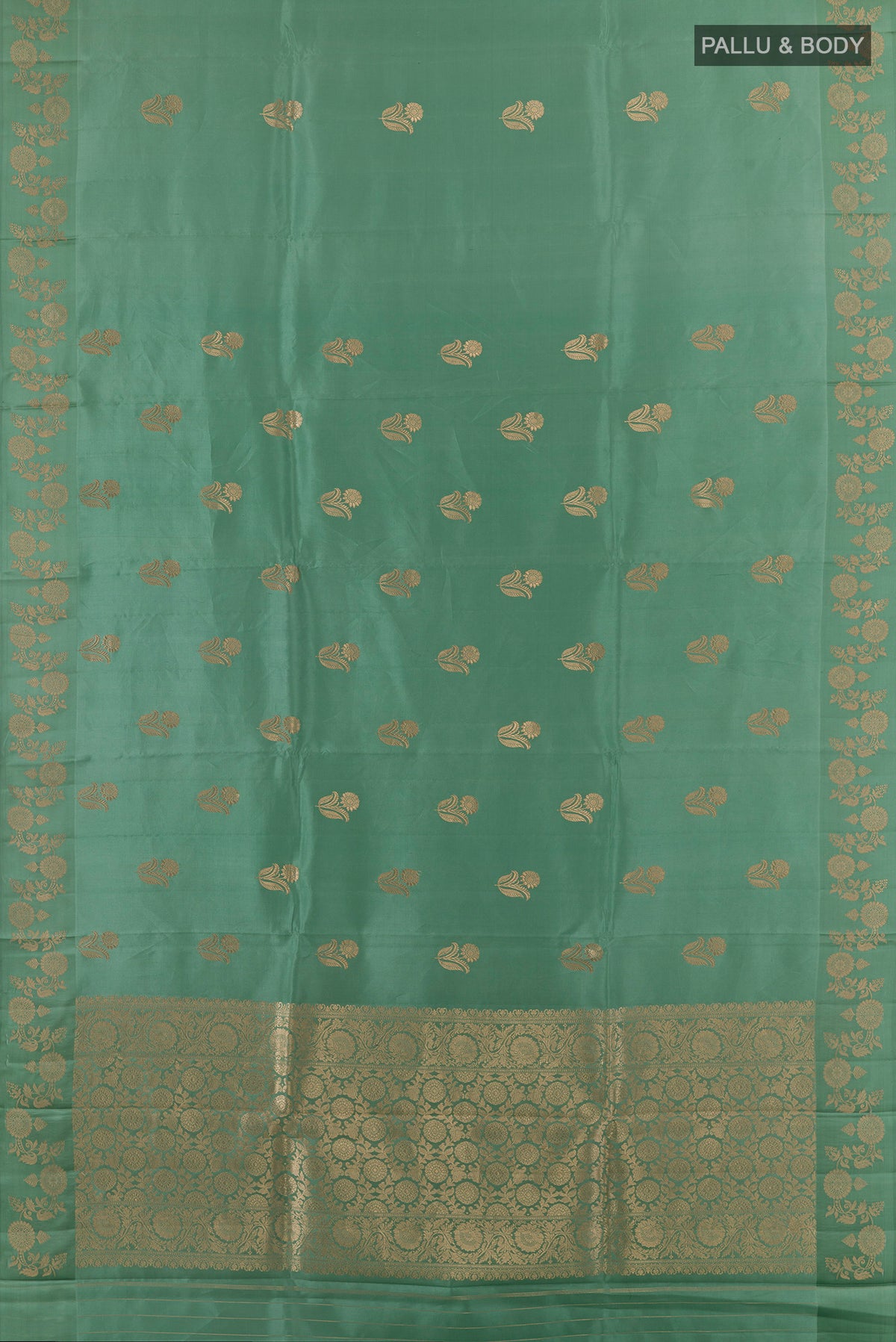 Flat view of Pure Silk Sage Green Banarasi Katan Saree with Zari Butta on the body and Zari Border. 