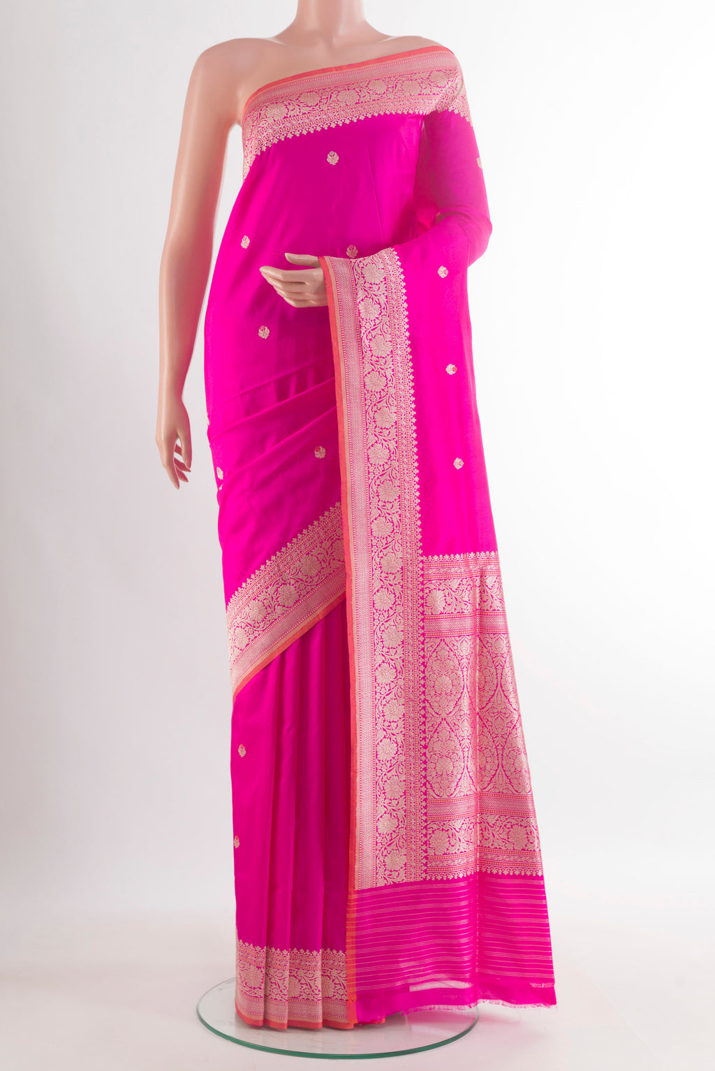 Pure Silk Rani Pink Banarasi Saree with Zari Butta on the body and Zari Border.  displayed on a mannequin