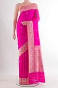 Pure Silk Rani Pink Banarasi Saree with Zari Butta on the body and Zari Border.  displayed on a mannequin