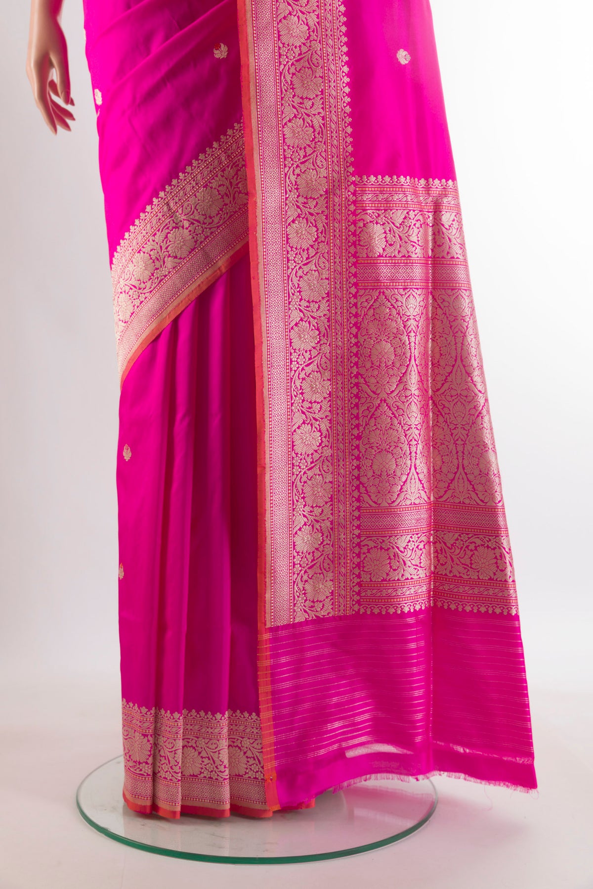 Pleats and pallu of Pure Silk Rani Pink Banarasi Saree with Zari Butta on the body and Zari Border. 