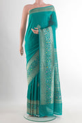 Pure Silk Sea Green Banarasi Tussar Saree with Zari Butta on the body and Zari Border.  displayed on a mannequin