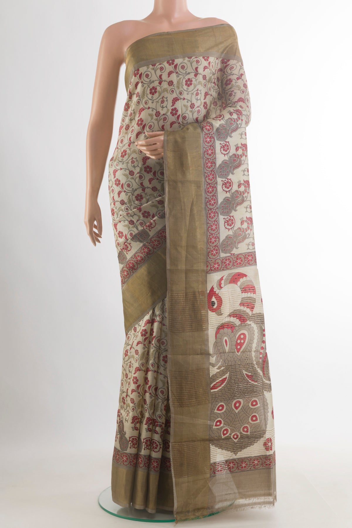 Off White Tussar Saree with Printed design on the body and Zari Border.  displayed on a mannequin