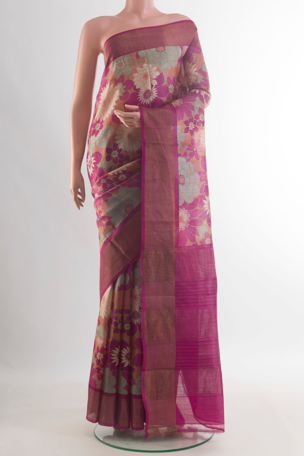Pink Tussar Saree with Floral Print on the body and Zari Border.  displayed on a mannequin