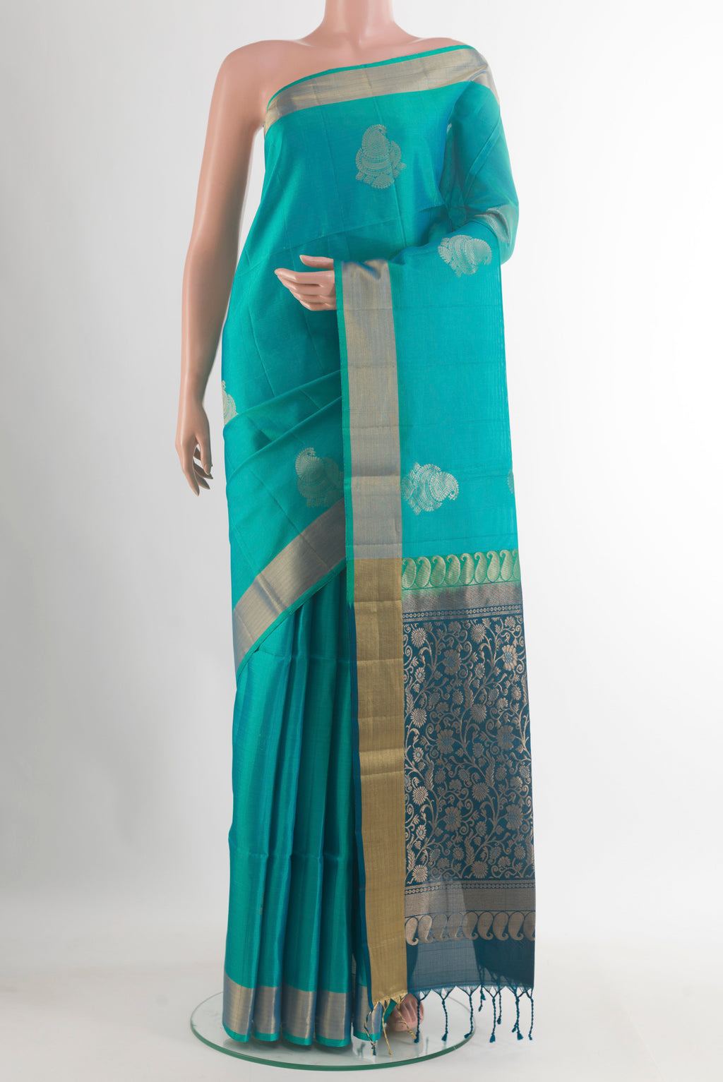 Pure Silk Sea Green Soft Saree with Zari Butta on the body and Zari Border.  displayed on a mannequin