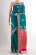 Pure Silk Peacock Blue Soft Saree with Zari Butta on the body and Zari Border.  displayed on a mannequin