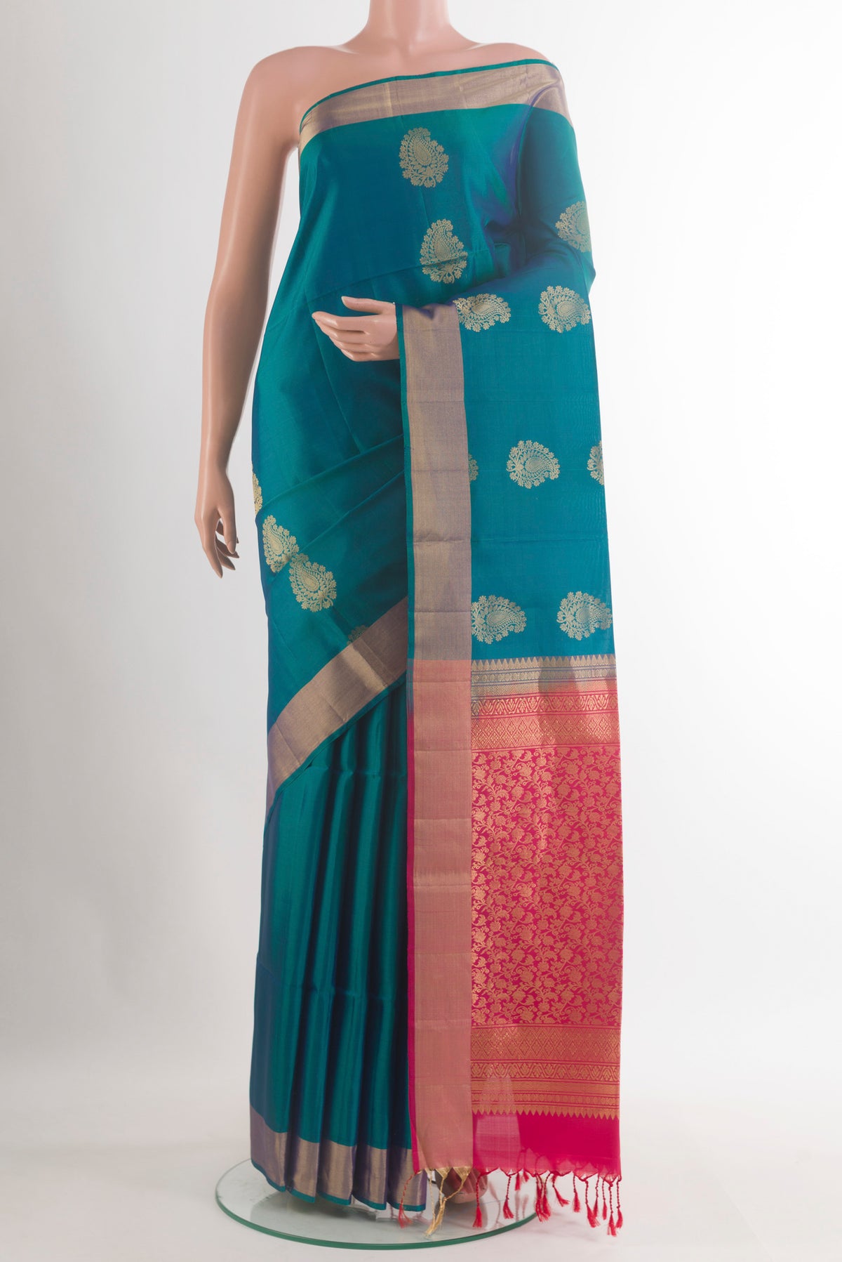 Pure Silk Peacock Blue Soft Saree with Zari Butta on the body and Zari Border.  displayed on a mannequin