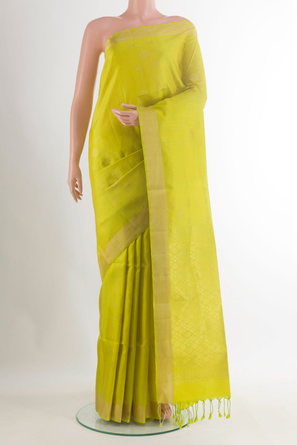 Pure Silk Green Soft Saree with Zari Butta on the body and Zari Border.  displayed on a mannequin