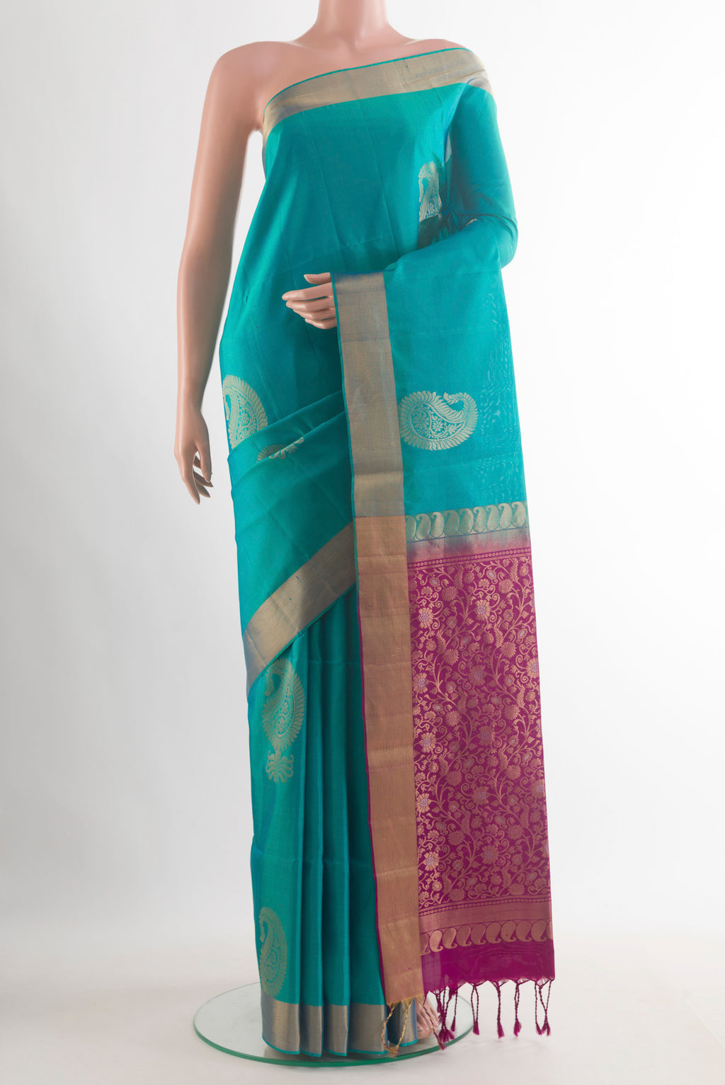 Pure Silk Sea Green Soft Saree with Zari Butta on the body and Zari Border.  displayed on a mannequin