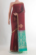 Pure Silk Maroon Soft Saree with Zari Butta on the body and Zari Border.  displayed on a mannequin