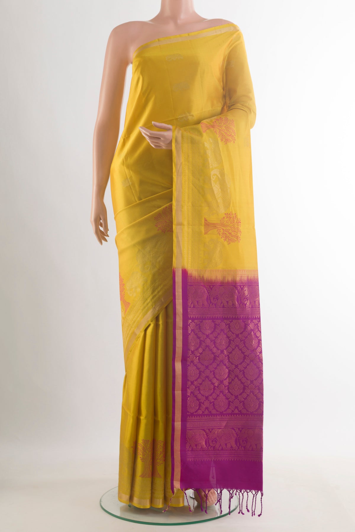 Pure Silk Yellow Soft Saree with Zari Butta on the body and Zari Border.  displayed on a mannequin