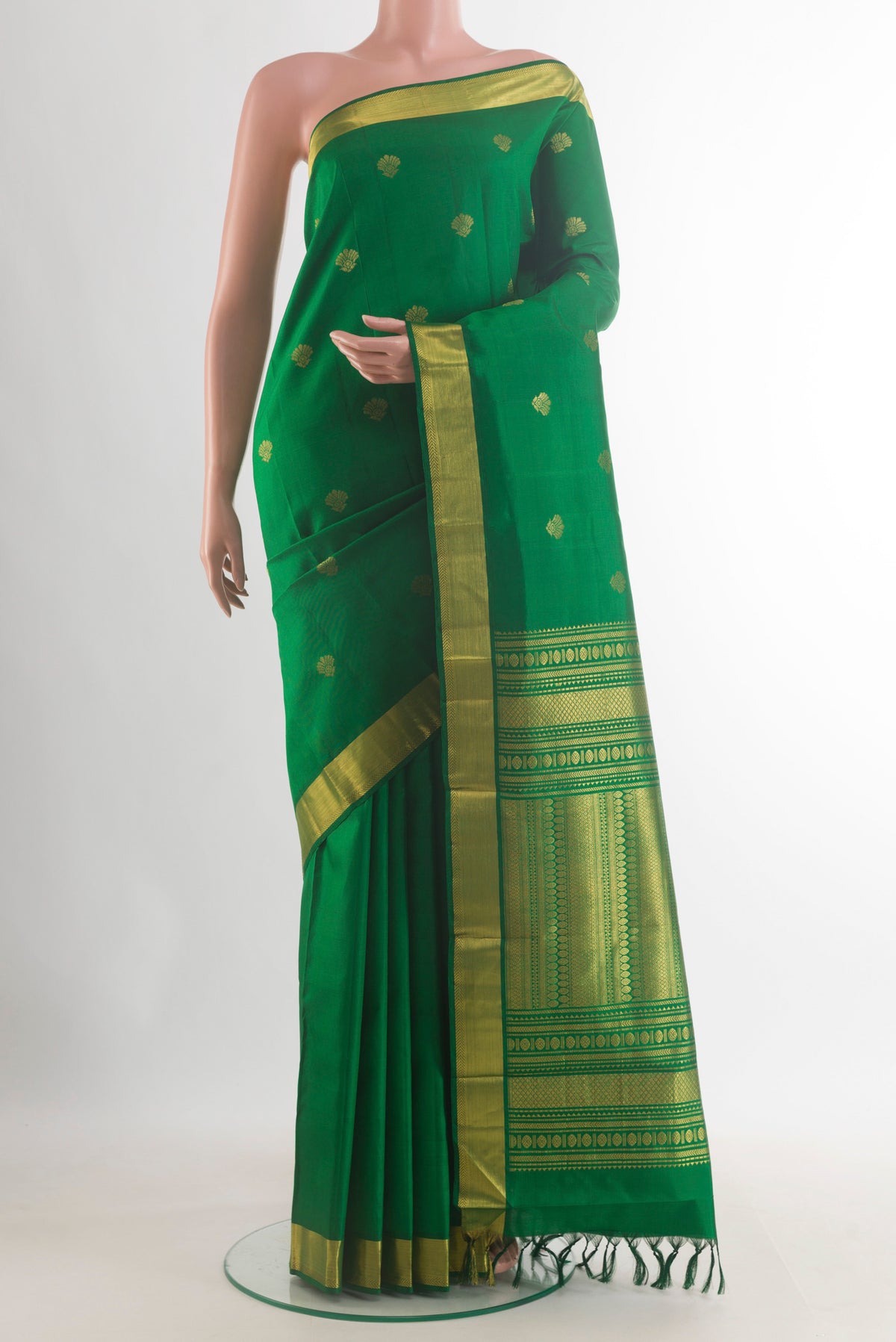 Pure Silk Green Kanjivaram Saree with Zari Butta on the body and Zari Border.  displayed on a mannequin