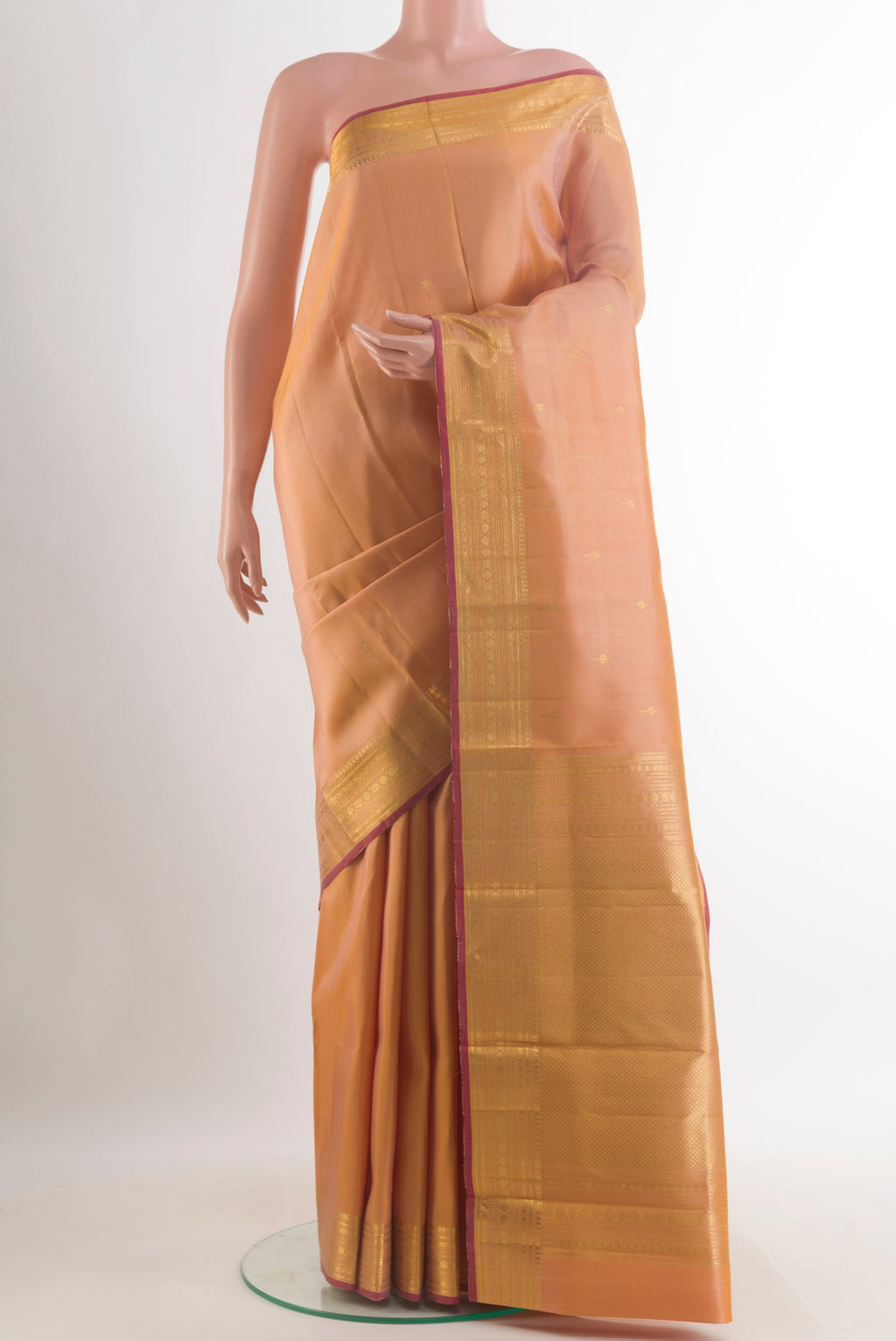 Pure Silk Sandal Kanjivaram Saree with Zari Butta on the body and Zari Border.  displayed on a mannequin