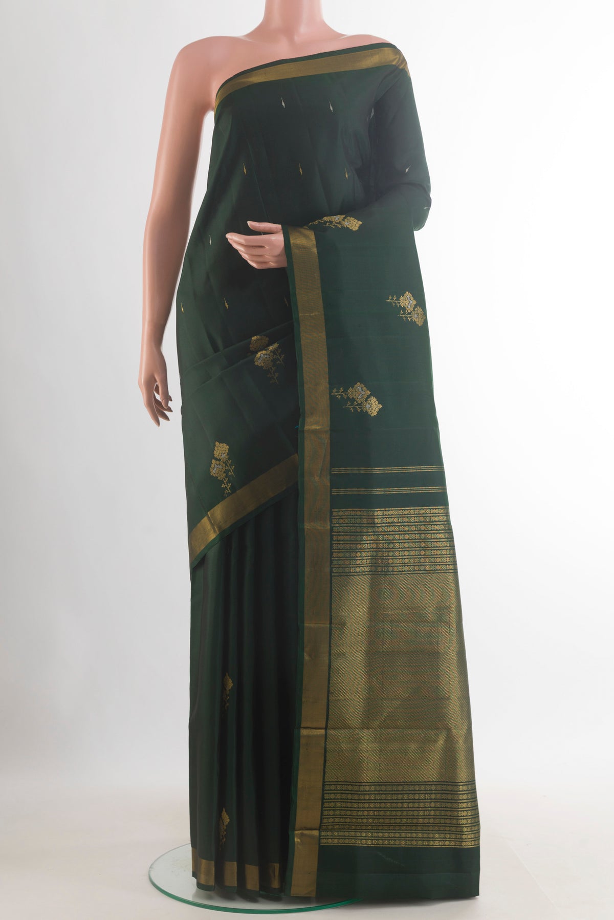 Pure Silk Bottle Green Kanjivaram Saree with Zari Butta on the body and Zari Border.  displayed on a mannequin