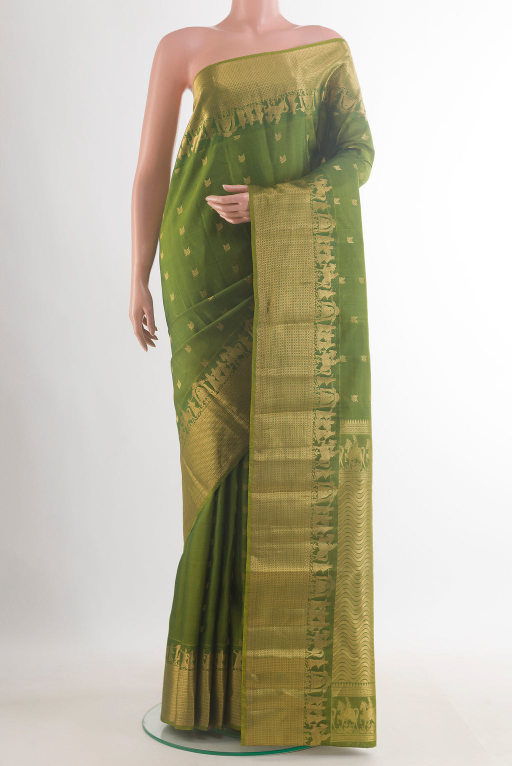 Pure Silk Mehandi Green Kanchipuram Saree with Zari Butta on the body and Zari Border.  displayed on a mannequin