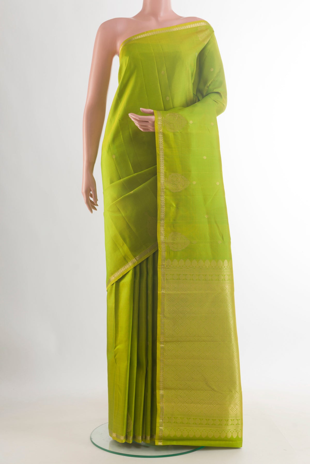 Pure Silk Green Kanchipuram Saree with Zari Butta on the body and Zari Border.  displayed on a mannequin