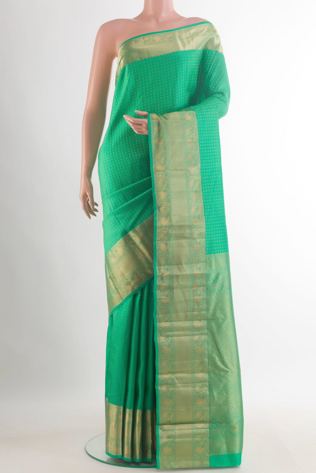 Pure Silk Green Kanjivaram Saree with Zari Butta on the body and Zari Border.  displayed on a mannequin