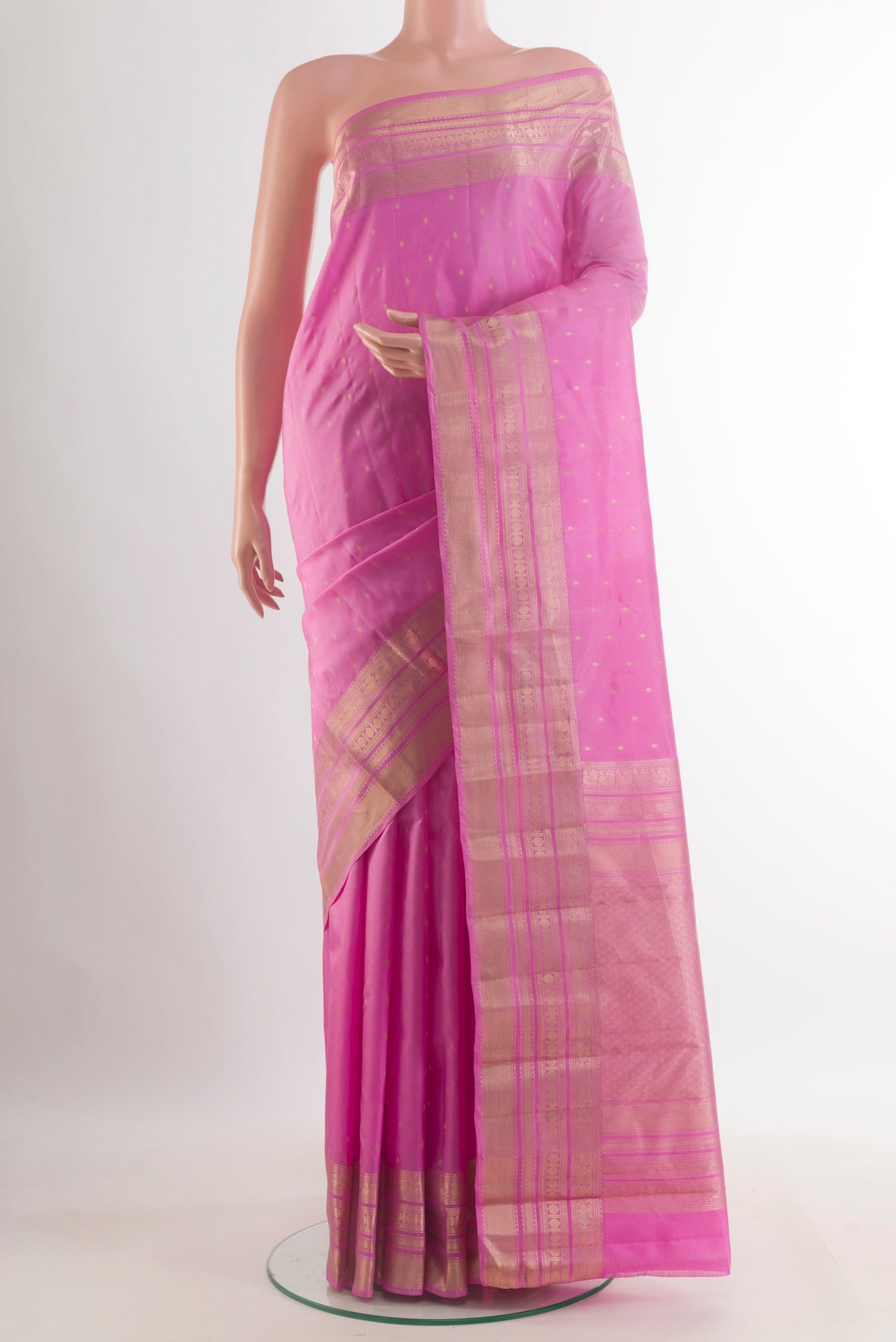 Pure Silk Pink Kanchipuram Saree with Zari Butta on the body and Zari Border.  displayed on a mannequin