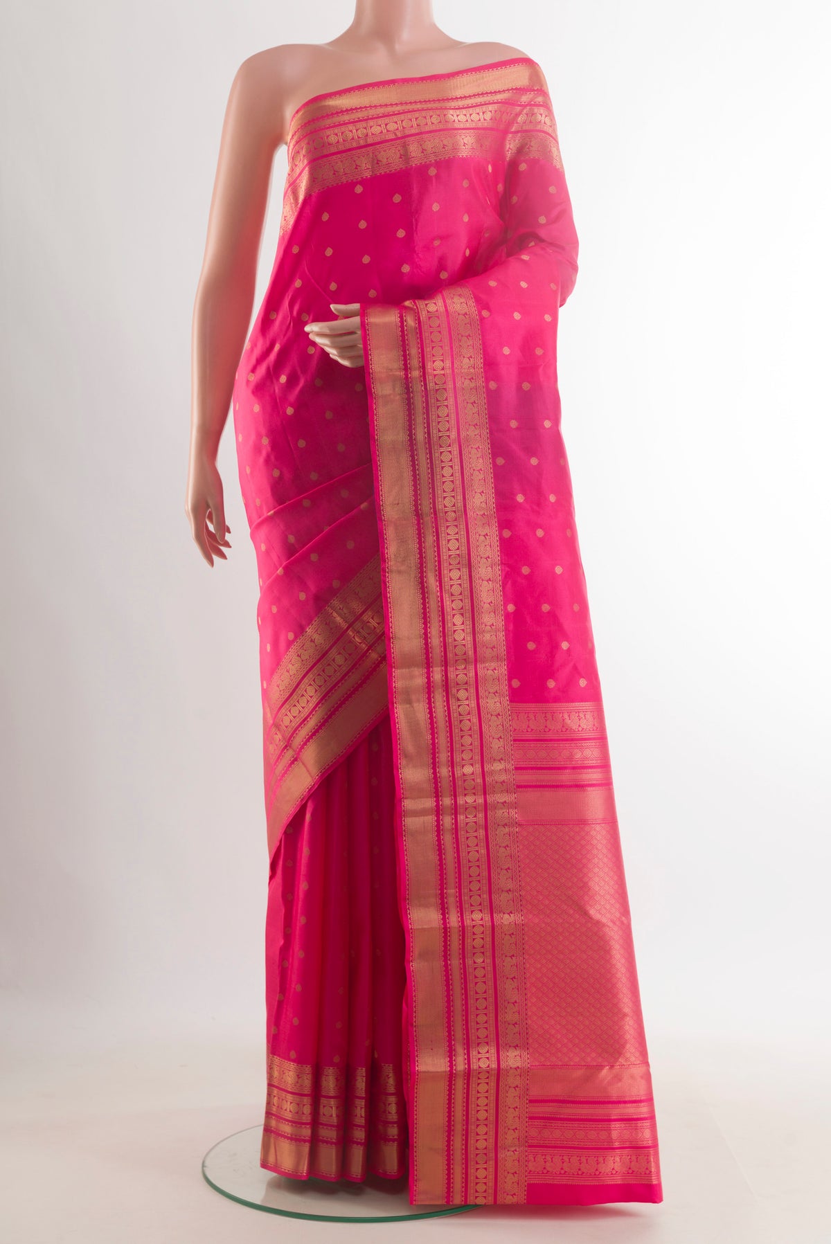 Pure Silk Pink Kanchipuram Saree with Zari Butta on the body and Zari Border.  displayed on a mannequin