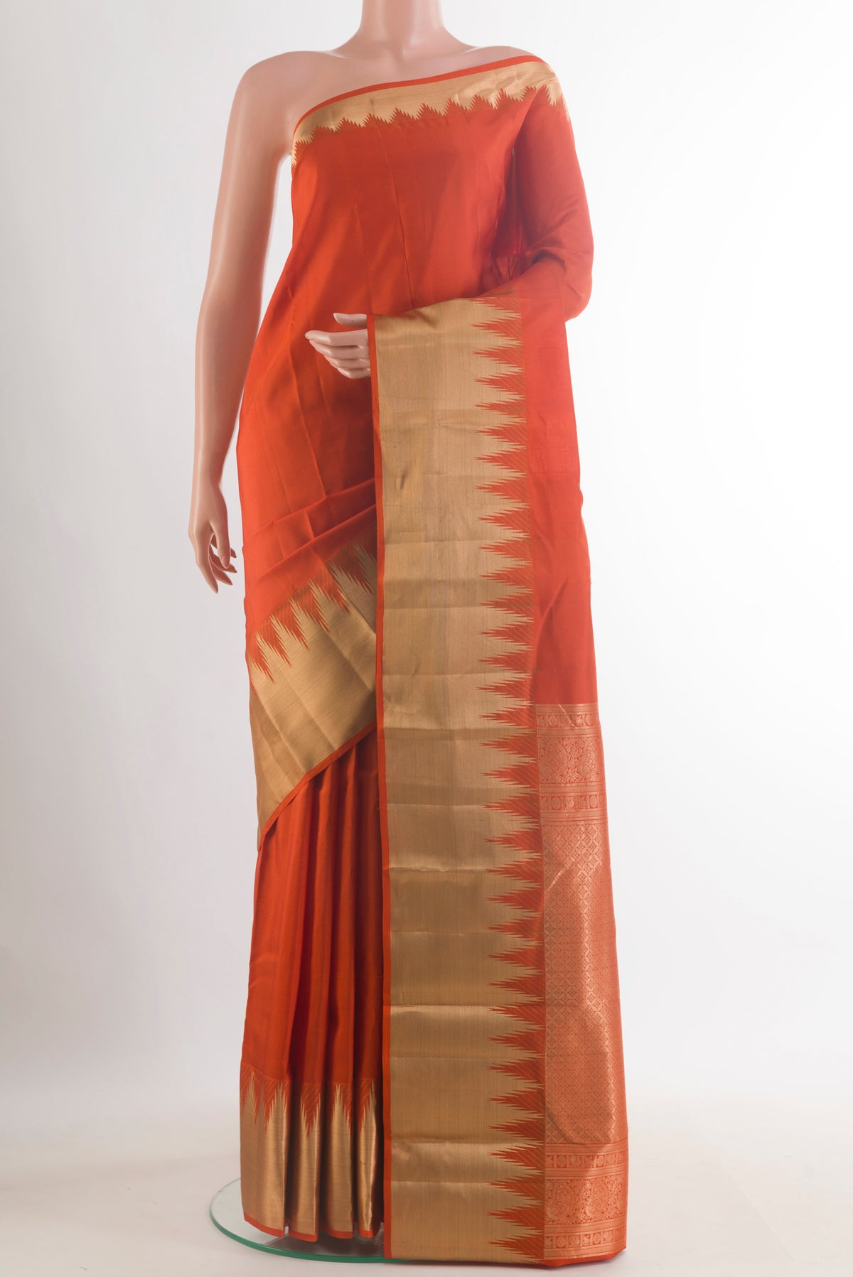 Pure Silk Orange Kanchipuram Saree with Plain Body and Zari Border.  displayed on a mannequin