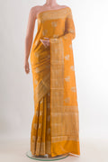 Yellow Tussar Saree with Zari Butta on the body and Zari Border.  displayed on a mannequin