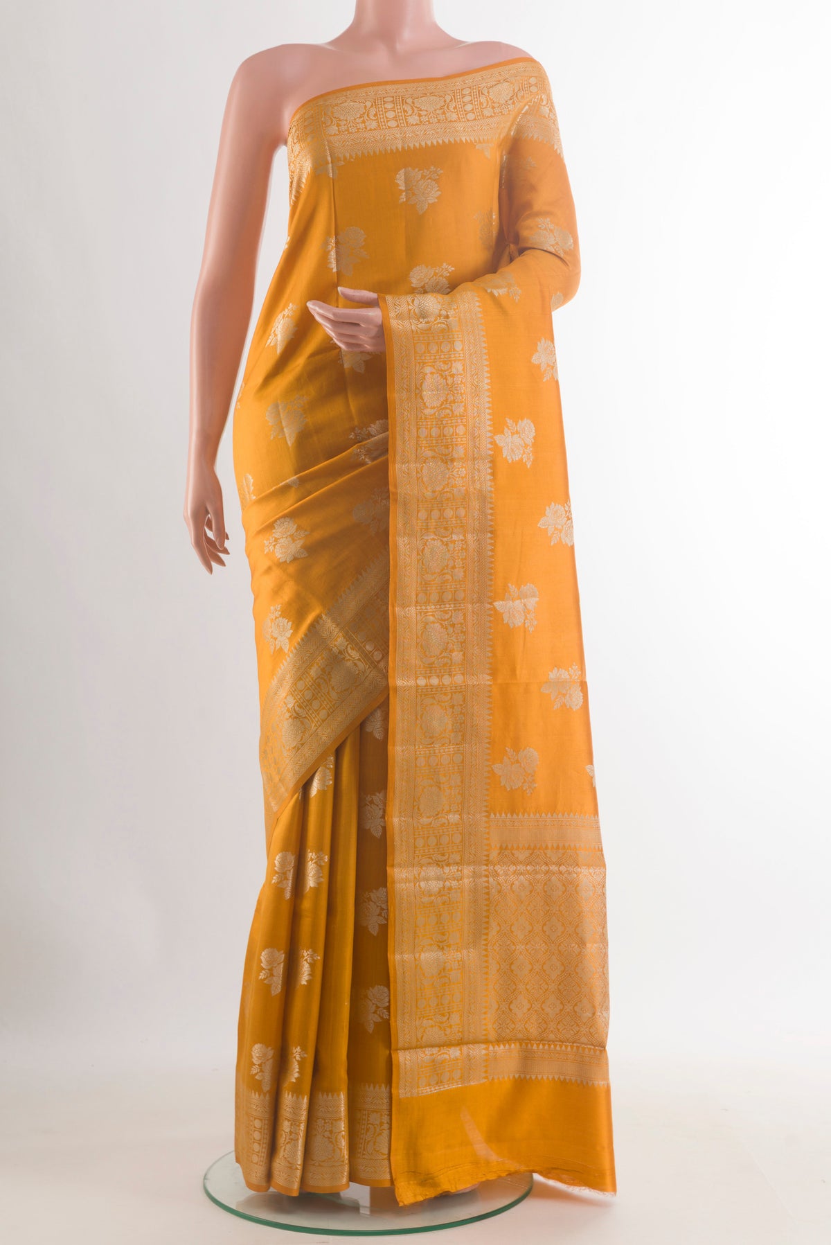 Yellow Tussar Saree with Zari Butta on the body and Zari Border.  displayed on a mannequin