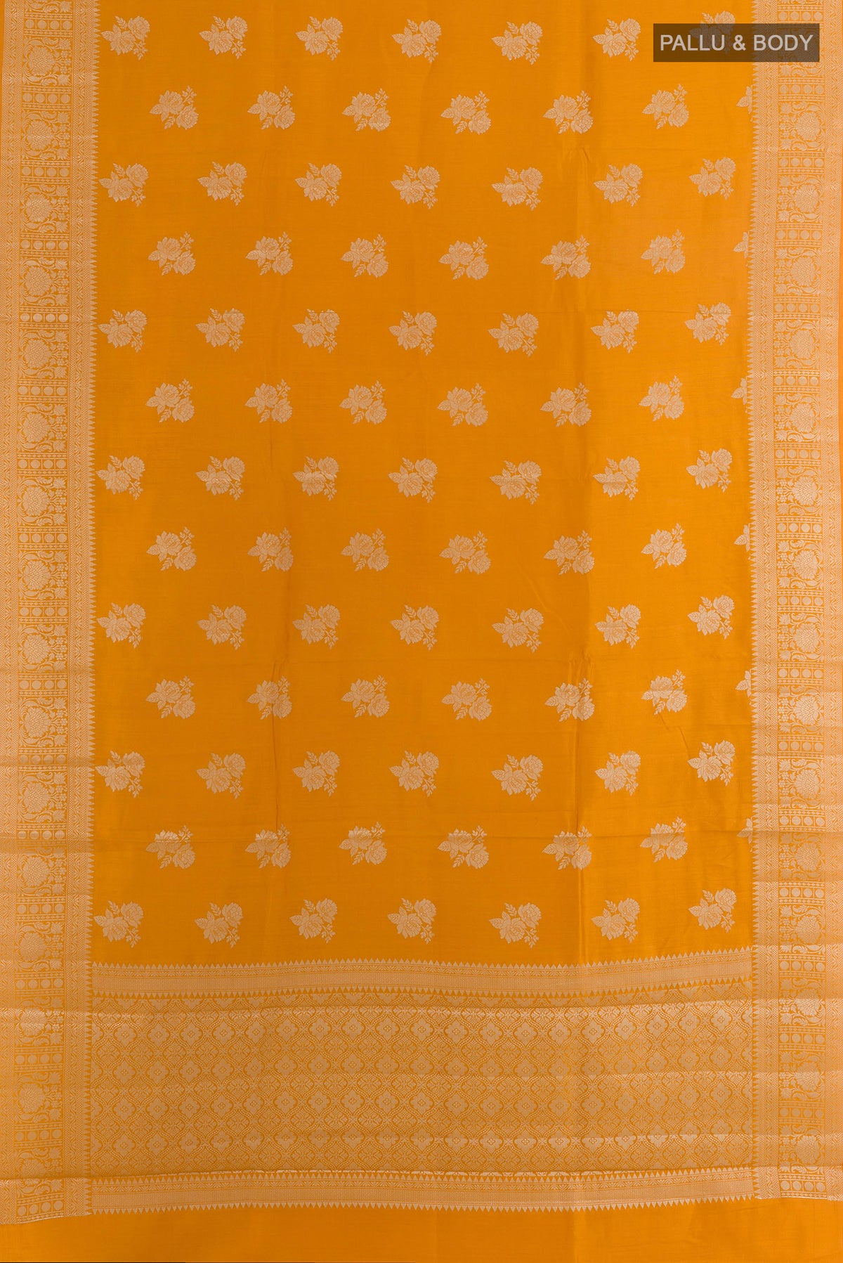 Flat view of Yellow Tussar Saree with Zari Butta on the body and Zari Border. 