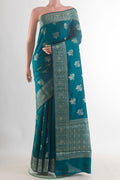 Teal Tussar Saree with Zari Butta on the body and Zari Border.  displayed on a mannequin