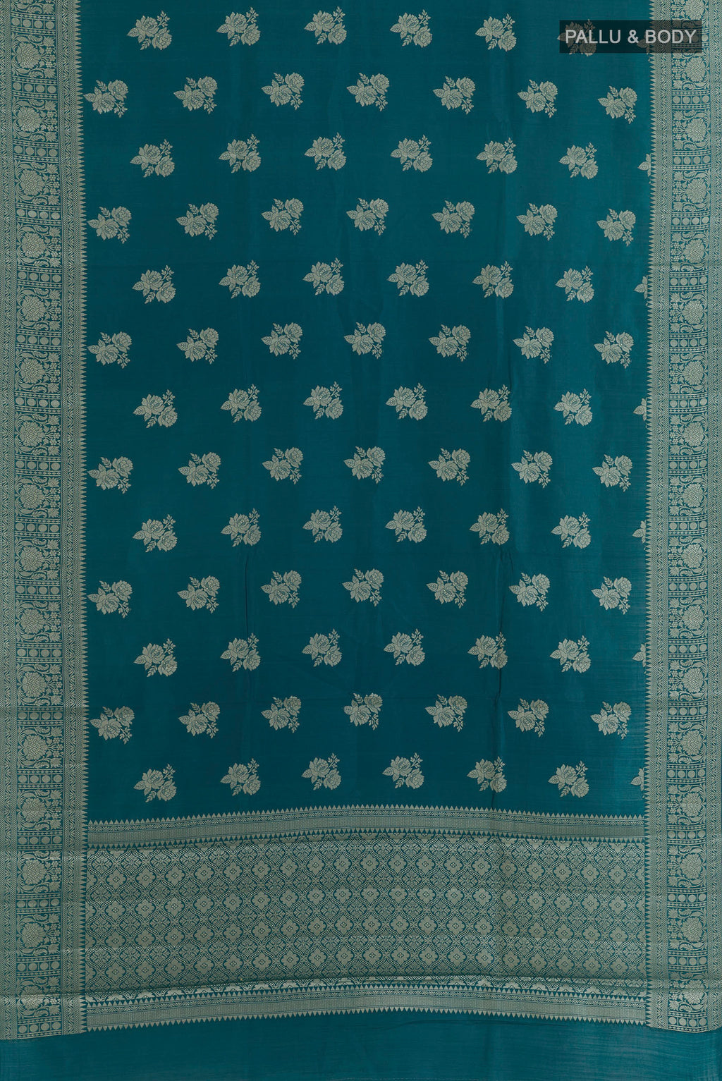 Flat view of Teal Tussar Saree with Zari Butta on the body and Zari Border. 