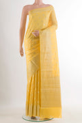 Yellow Tussar Saree with Zari Butta on the body and Zari Border.  displayed on a mannequin