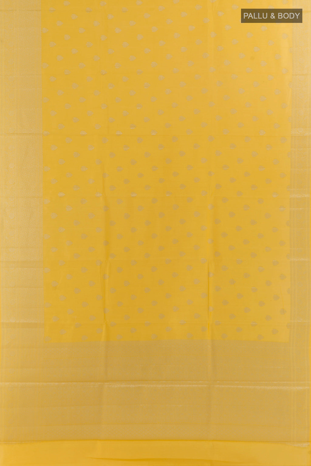Flat view of Yellow Tussar Saree with Zari Butta on the body and Zari Border. 