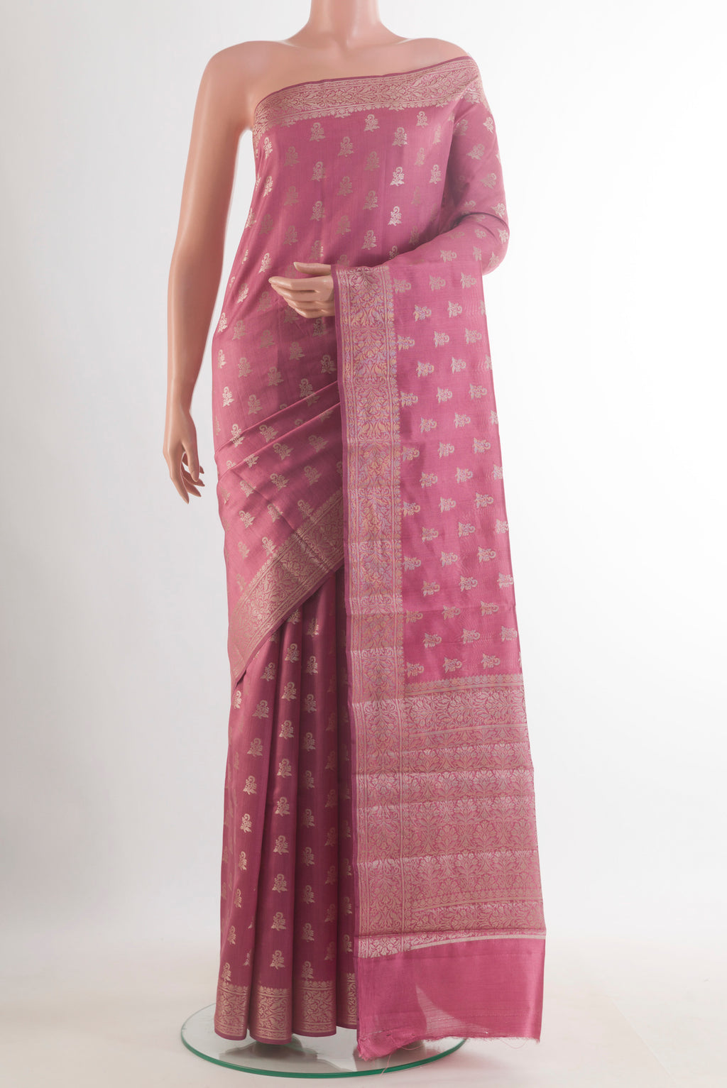 Pink Tussar Saree with Zari Butta on the body and Zari Border.  displayed on a mannequin