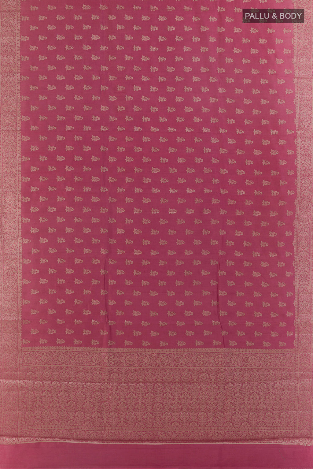 Flat view of Pink Tussar Saree with Zari Butta on the body and Zari Border. 