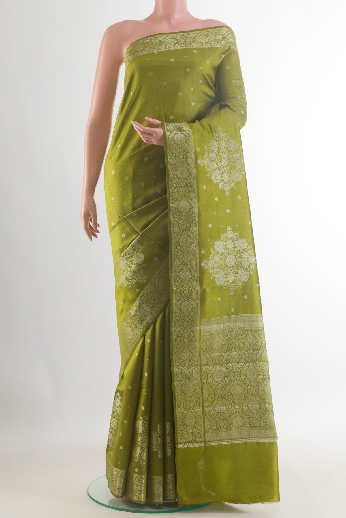 Mehandi Green Tussar Saree with Zari Butta on the body and Zari Border.  displayed on a mannequin