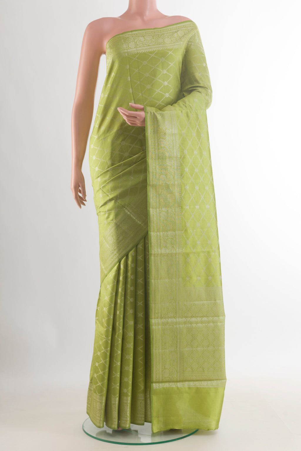 Green Tussar Saree with Zari Brocade on the body and Zari Border.  displayed on a mannequin