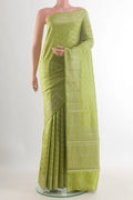 Green Tussar Saree with Zari Brocade on the body and Zari Border.  displayed on a mannequin