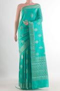 Sea Green Tussar Saree with Zari Butta on the body and Zari Border.  displayed on a mannequin