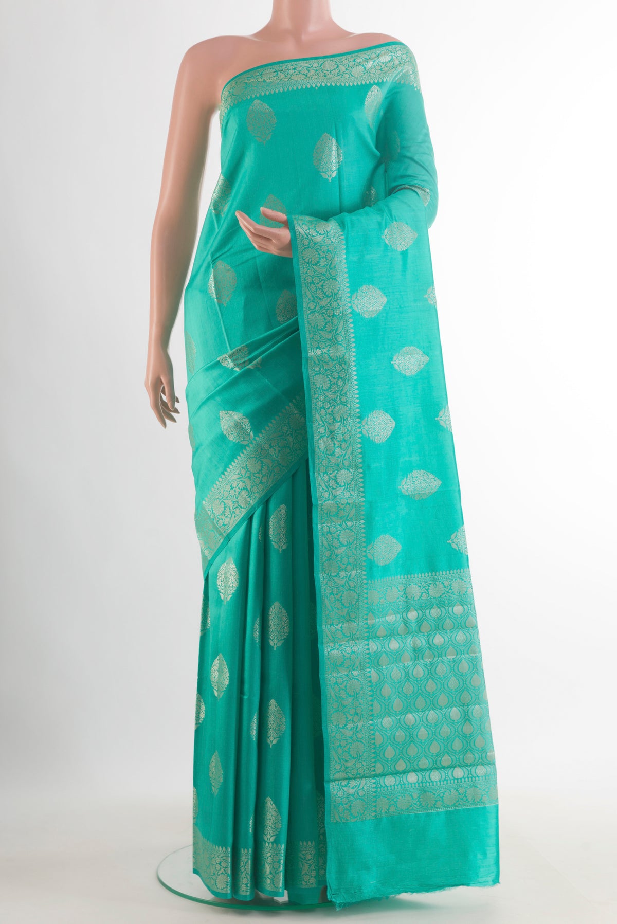 Sea Green Tussar Saree with Zari Butta on the body and Zari Border.  displayed on a mannequin