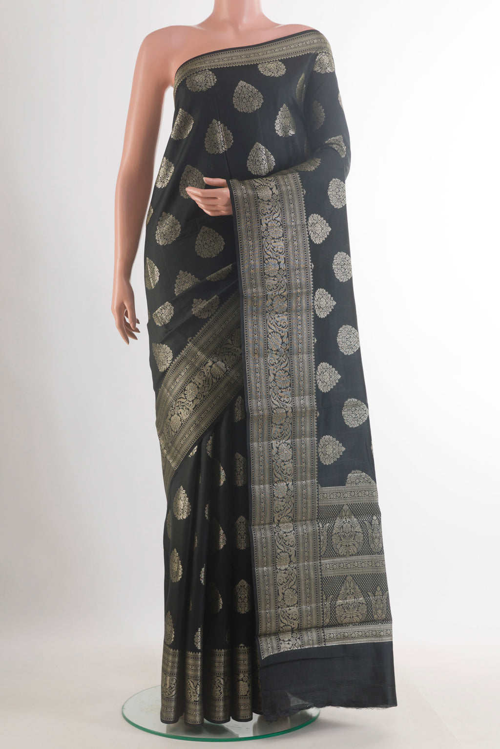 Black Tussar Saree with Zari Butta on the body and Zari Border.  displayed on a mannequin