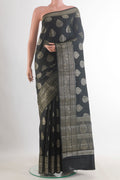 Black Tussar Saree with Zari Butta on the body and Zari Border.  displayed on a mannequin