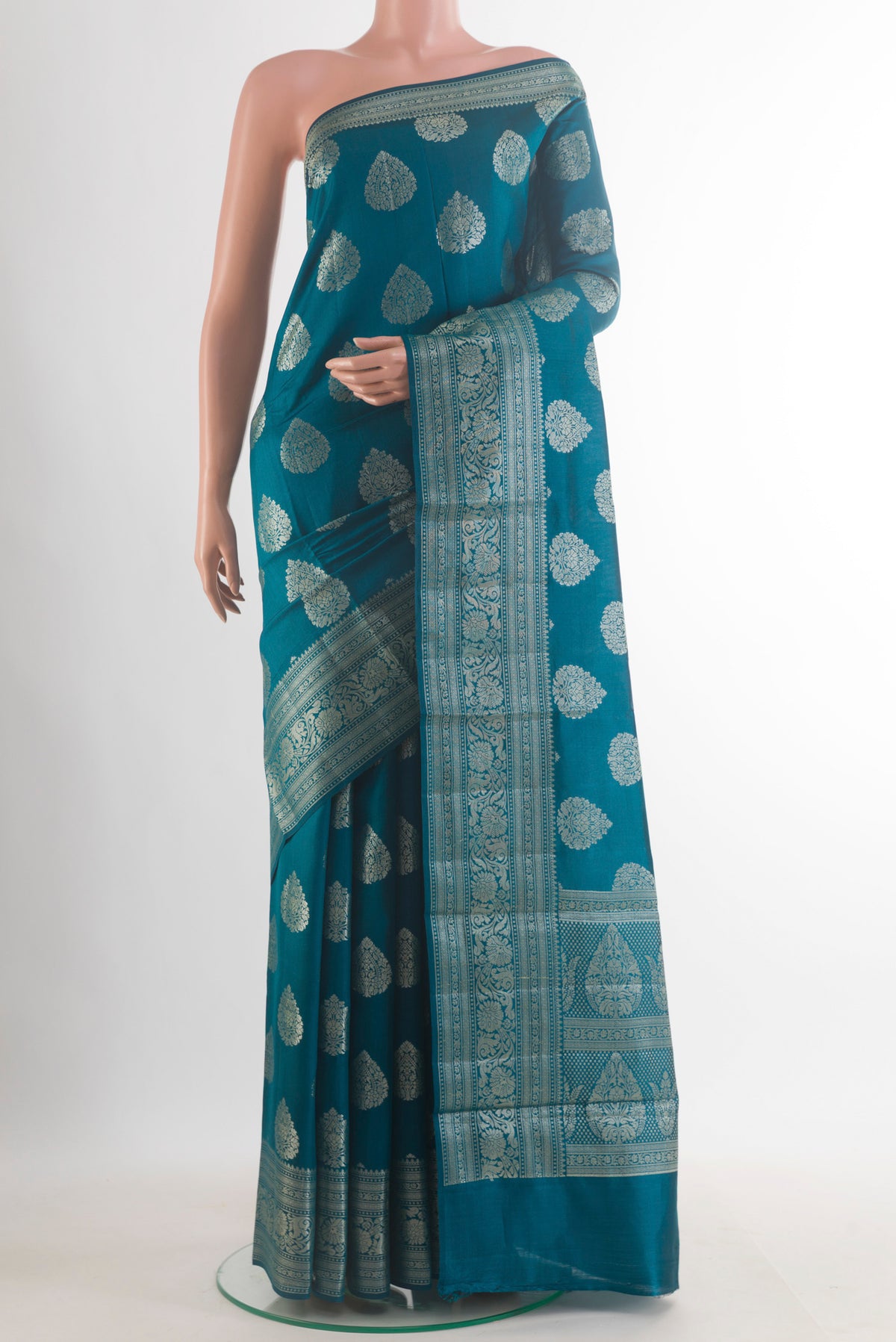 Peacock Blue Tussar Saree with Zari Butta on the body and Zari Border.  displayed on a mannequin