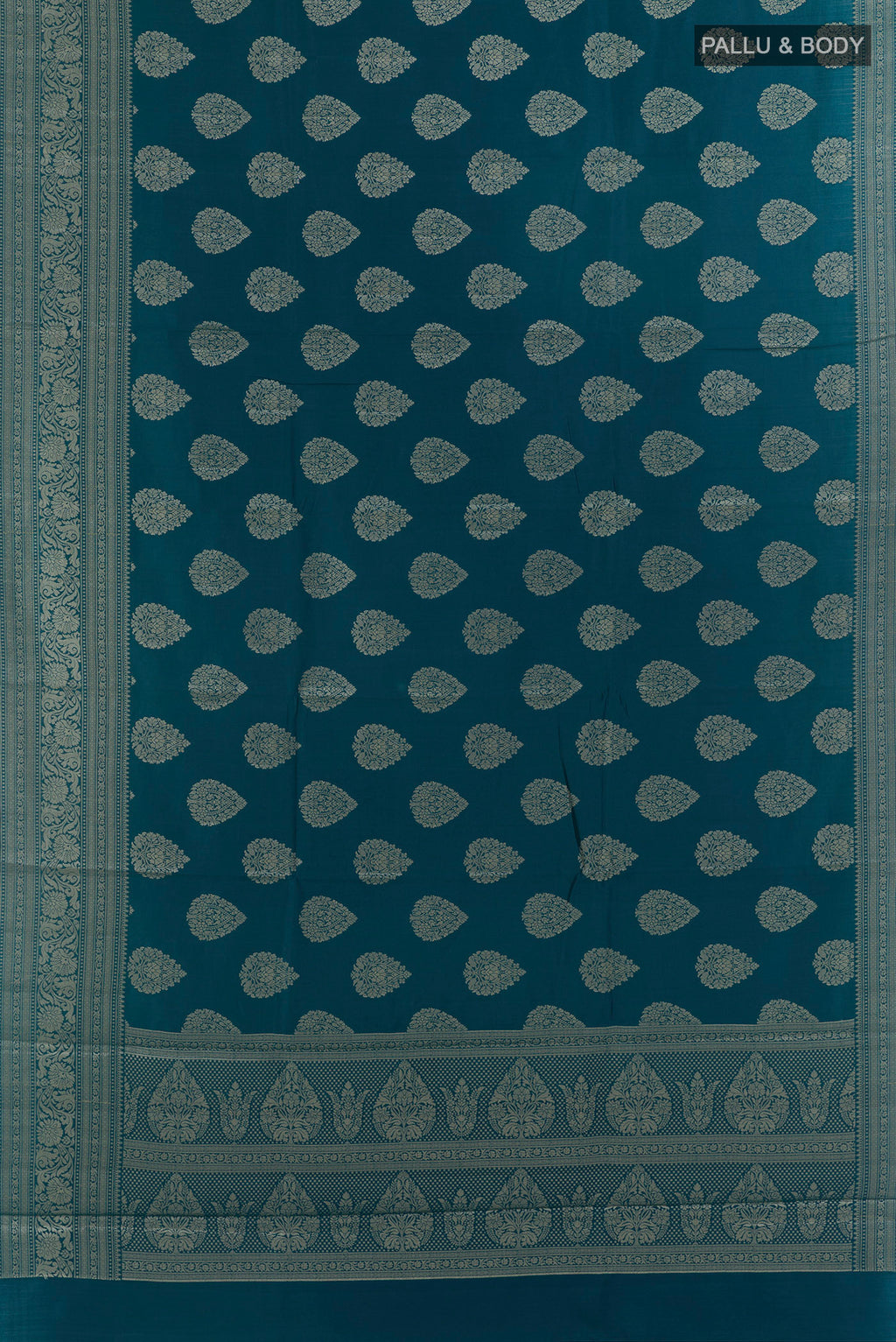 Flat view of Peacock Blue Tussar Saree with Zari Butta on the body and Zari Border. 